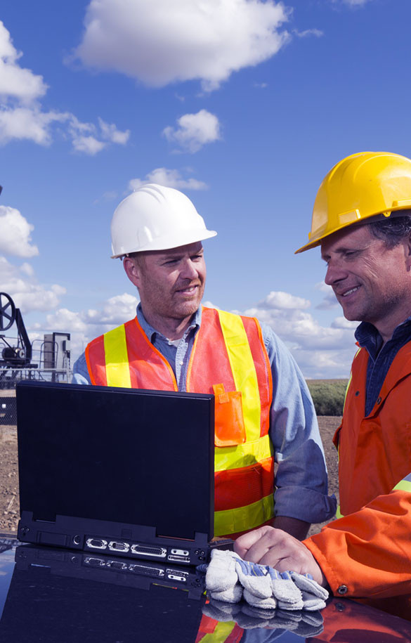 construction workers looking at laptop