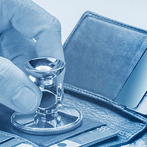 Stethoscope on top of open wallet