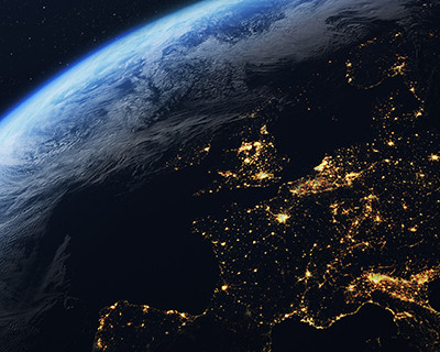 Earth viewed from space highlighting Europe illuminated by city lights