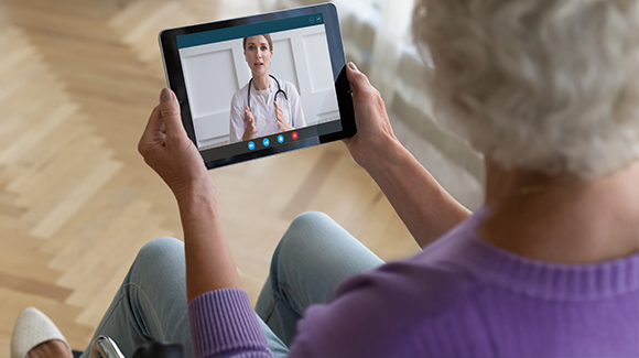 A lady doing a video consultation with a medical personnel 