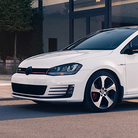 White Volkswagen vehicle shown from front to side mirror