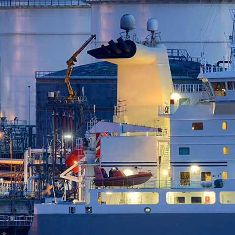 A ship at dock during dusk.