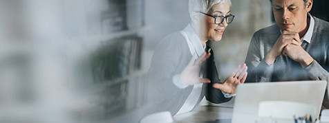 woman and man in front of laptop