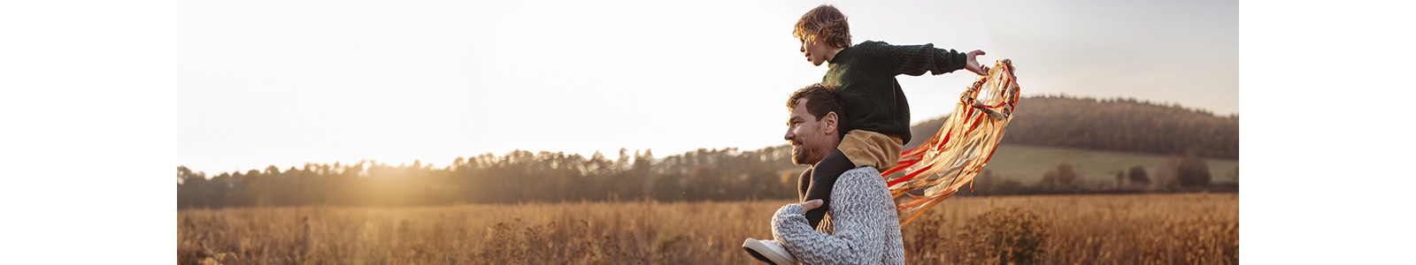 A man and a child are captured in mid-flight, sharing an exhilarating experience as they glide through the air.