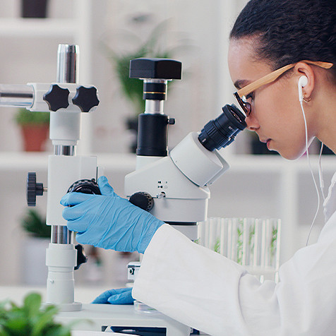 Lab technician using  a microscope