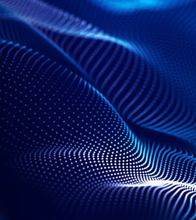 A digital image of a dark blue material in soft folds with white dots on it