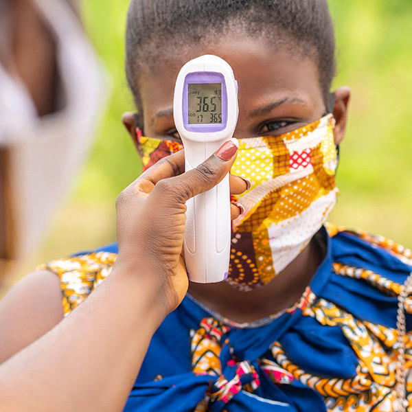 young woman getting her temperature taken